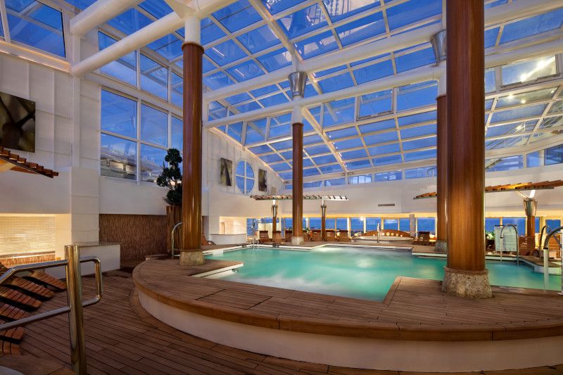 There is a large indoor swimming pool with a glass roof.