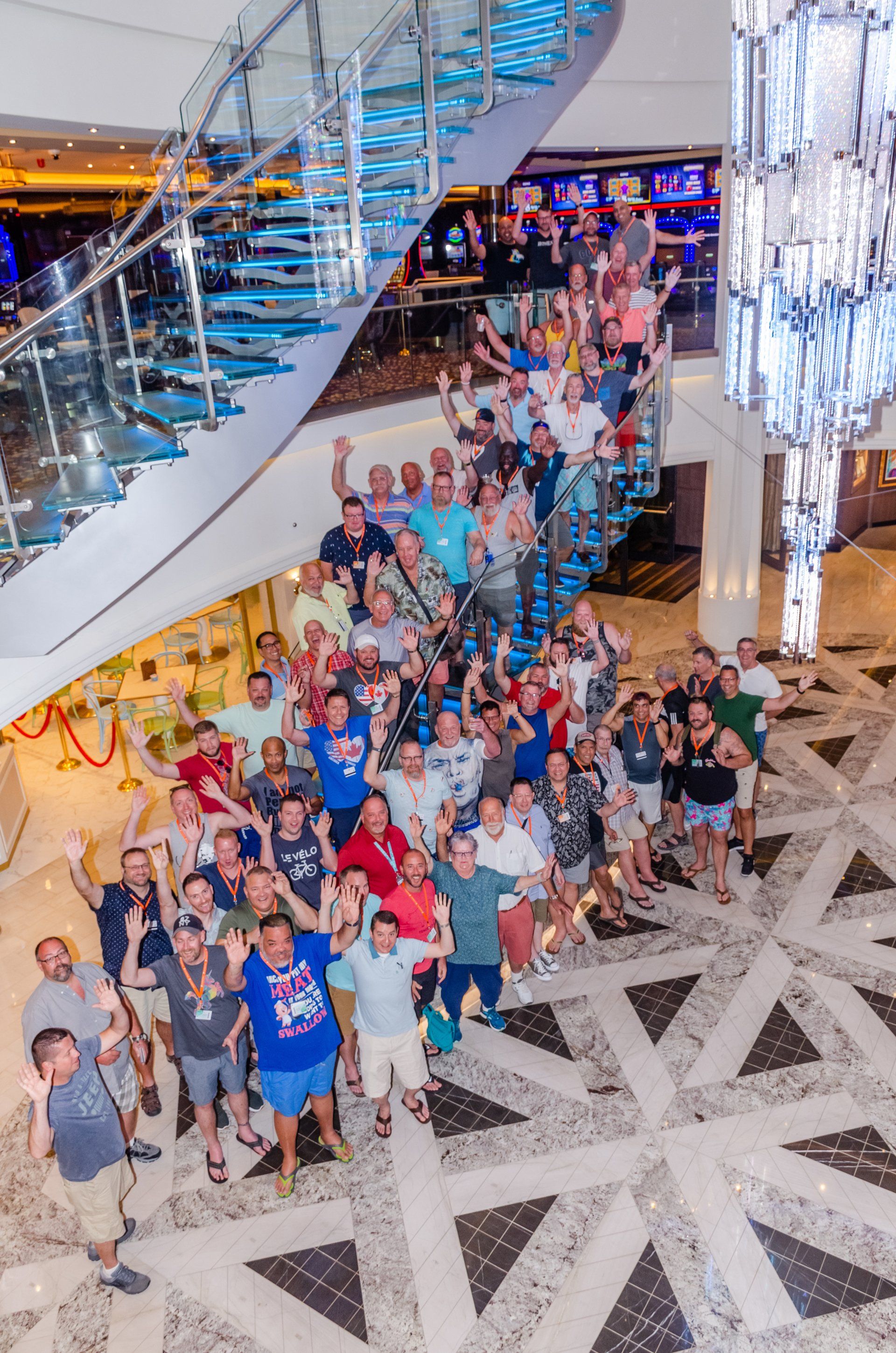 A large group of people are posing for a picture in a lobby.