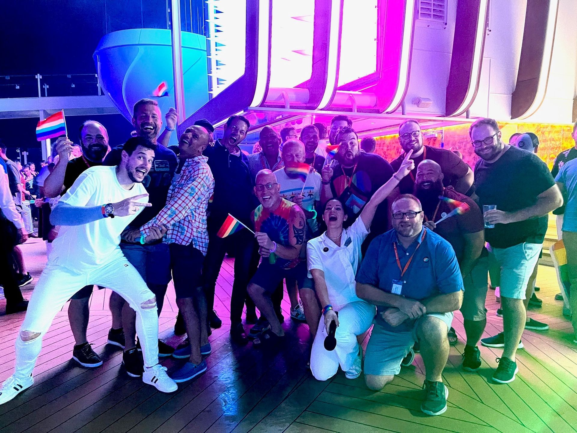 A group of people are posing for a picture on a cruise ship.