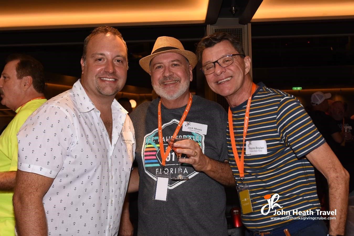 Three men are posing for a picture and one of them is wearing a hat.