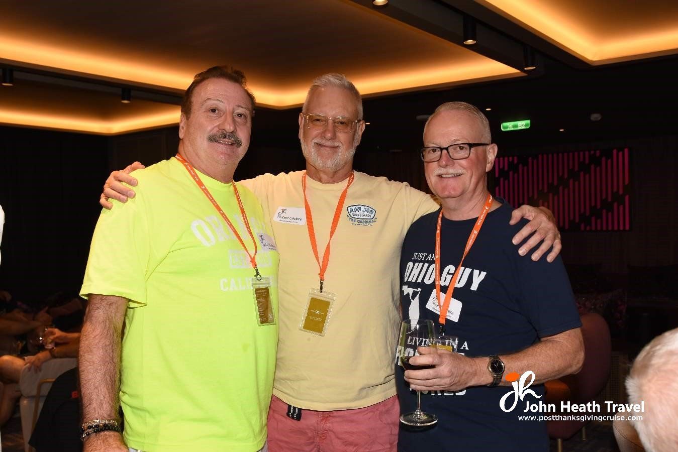 Three men are posing for a picture together in a room.