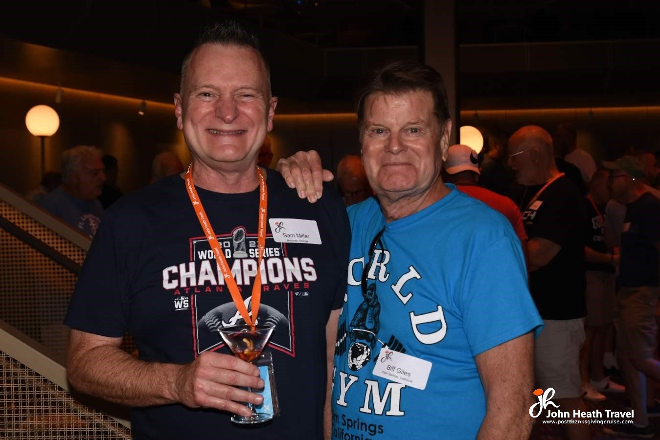 Two men are posing for a picture and one of them is wearing a champions shirt.