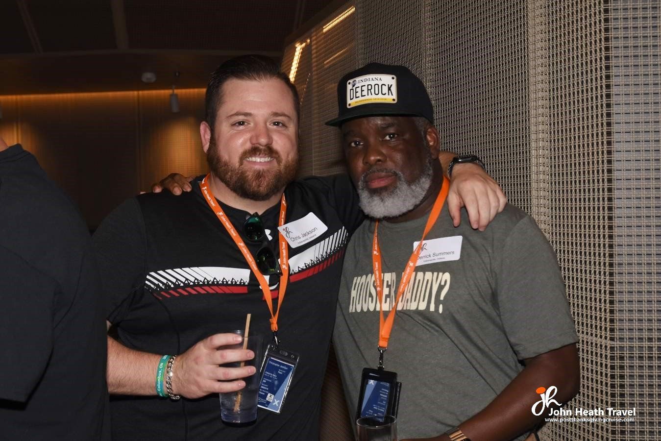 Two men are posing for a picture and one of them is wearing a shirt that says rock n ' roll
