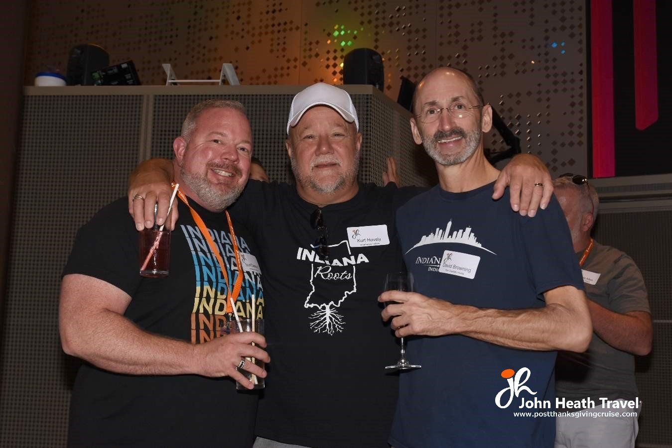 Three men posing for a picture with one wearing a shirt that says iowa