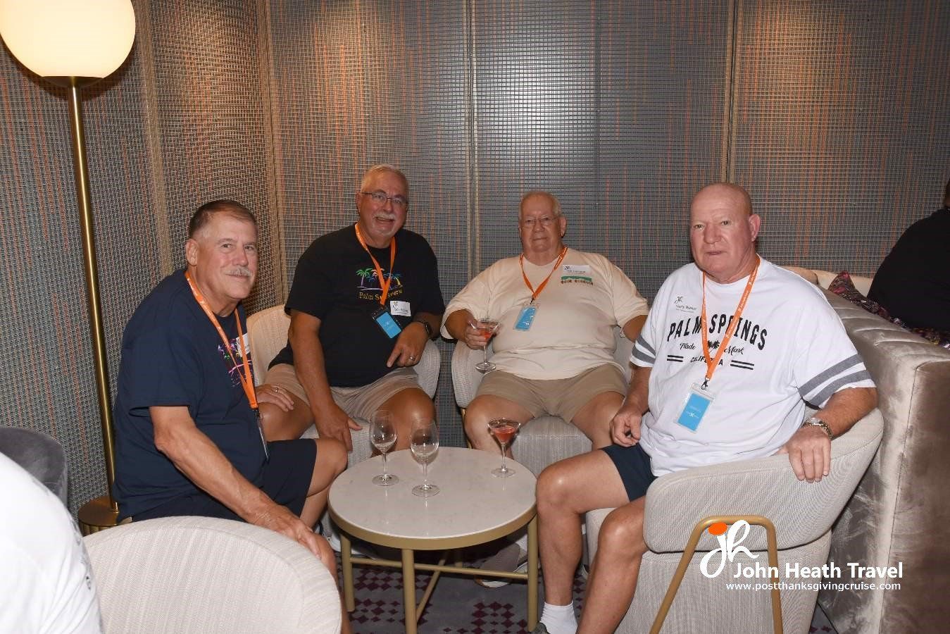 A group of men are sitting around a table in a room.
