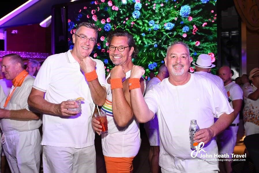 A group of men are posing for a picture in front of a christmas tree.