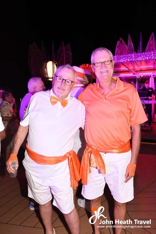 Two men are posing for a picture together at a party.