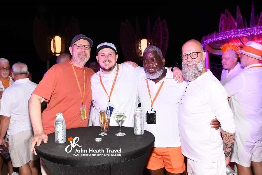 A group of men are posing for a picture at a party.