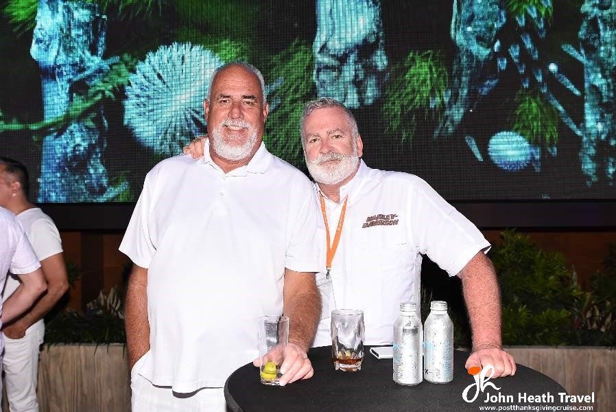 Two men are posing for a picture while standing next to each other.