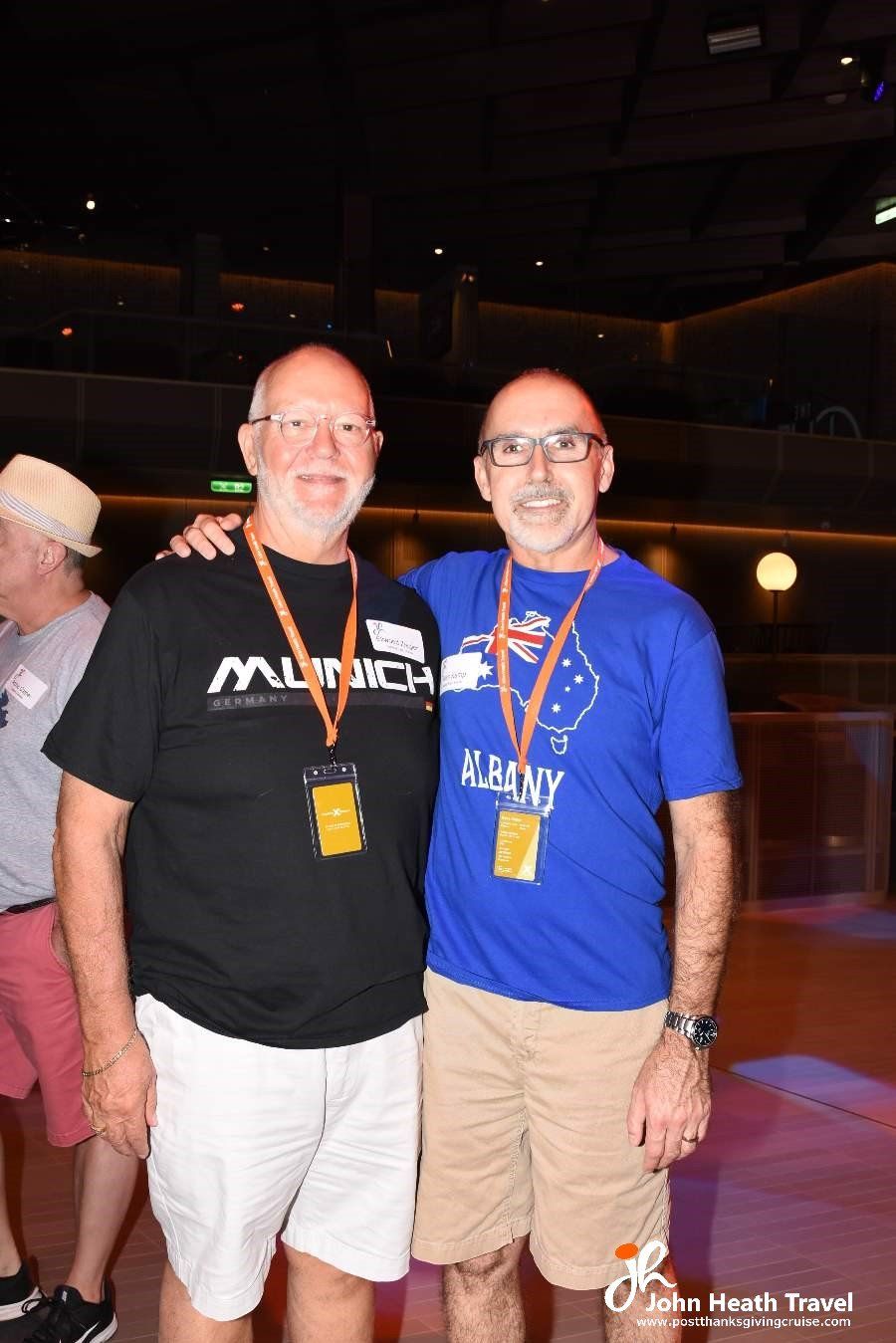 Two men are posing for a picture together and one of them is wearing a blue shirt.