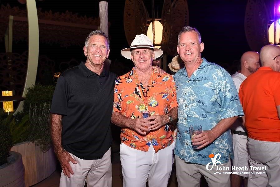 Three men are posing for a picture at a party.