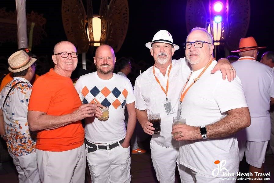 A group of men are posing for a picture at a party.