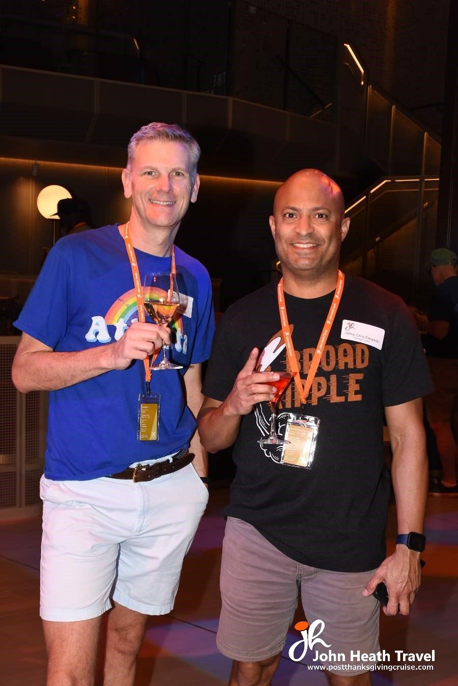 Two men are posing for a picture and one of them is wearing a shirt that says road simple