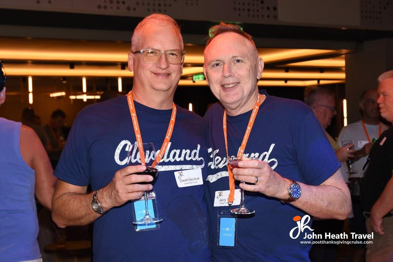 Two men wearing cleveland shirts are posing for a picture