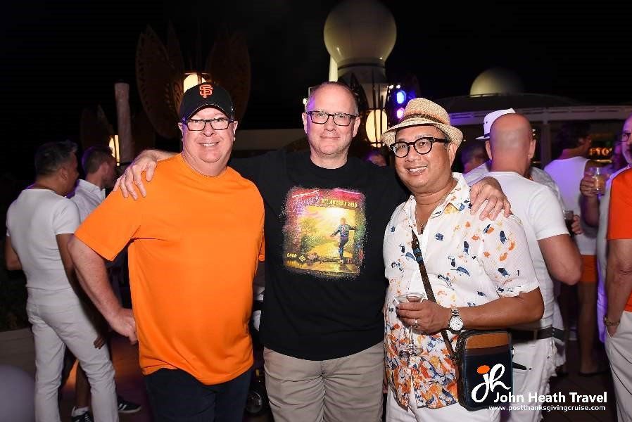 Three men are posing for a picture at a party.