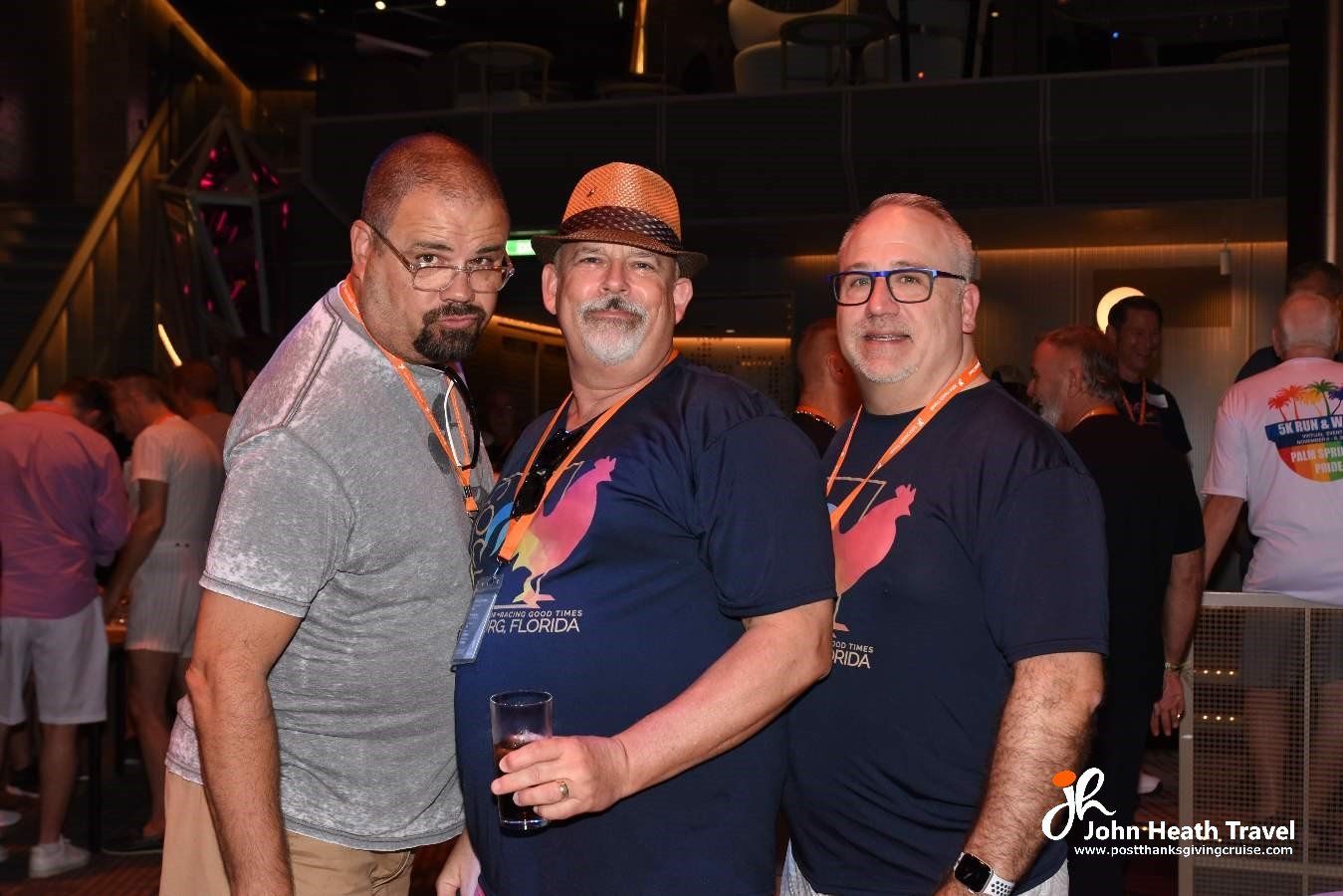 Three men are posing for a picture in a club.