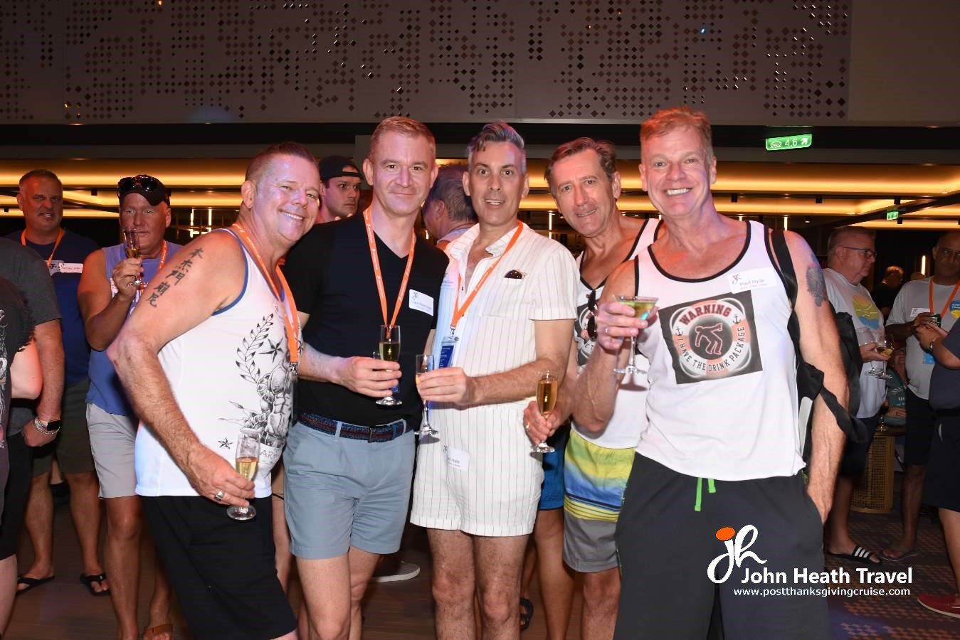 A group of men are posing for a picture while drinking champagne.