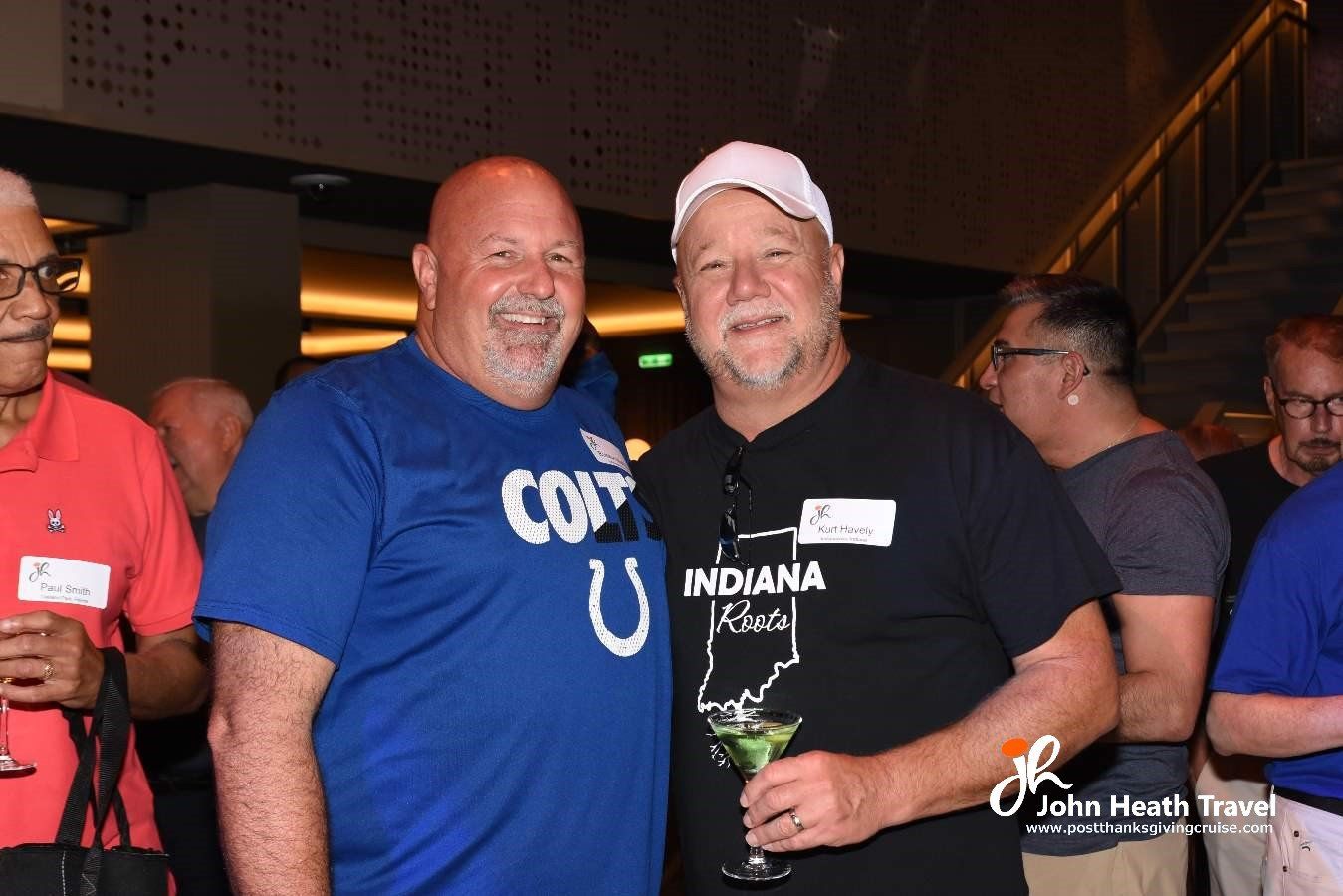 Two men posing for a picture with one wearing an indiana shirt
