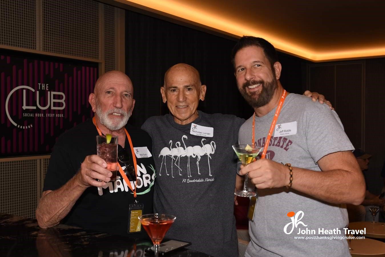 Three men are standing next to each other holding martini glasses.