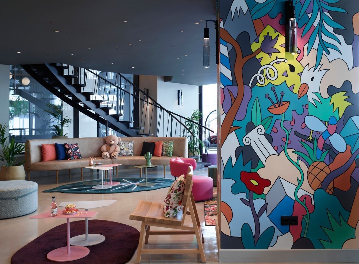 A living room with a colorful mural on the wall