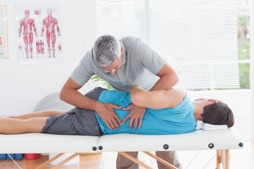 person assisting with back pain