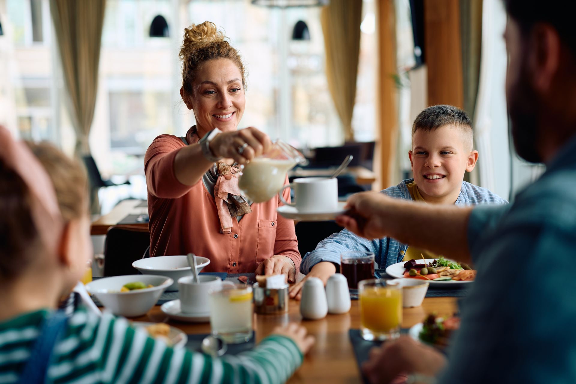 A family having breakfast in the hotel's dining area. 