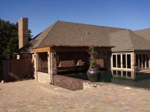 A large house with a swimming pool in front of it