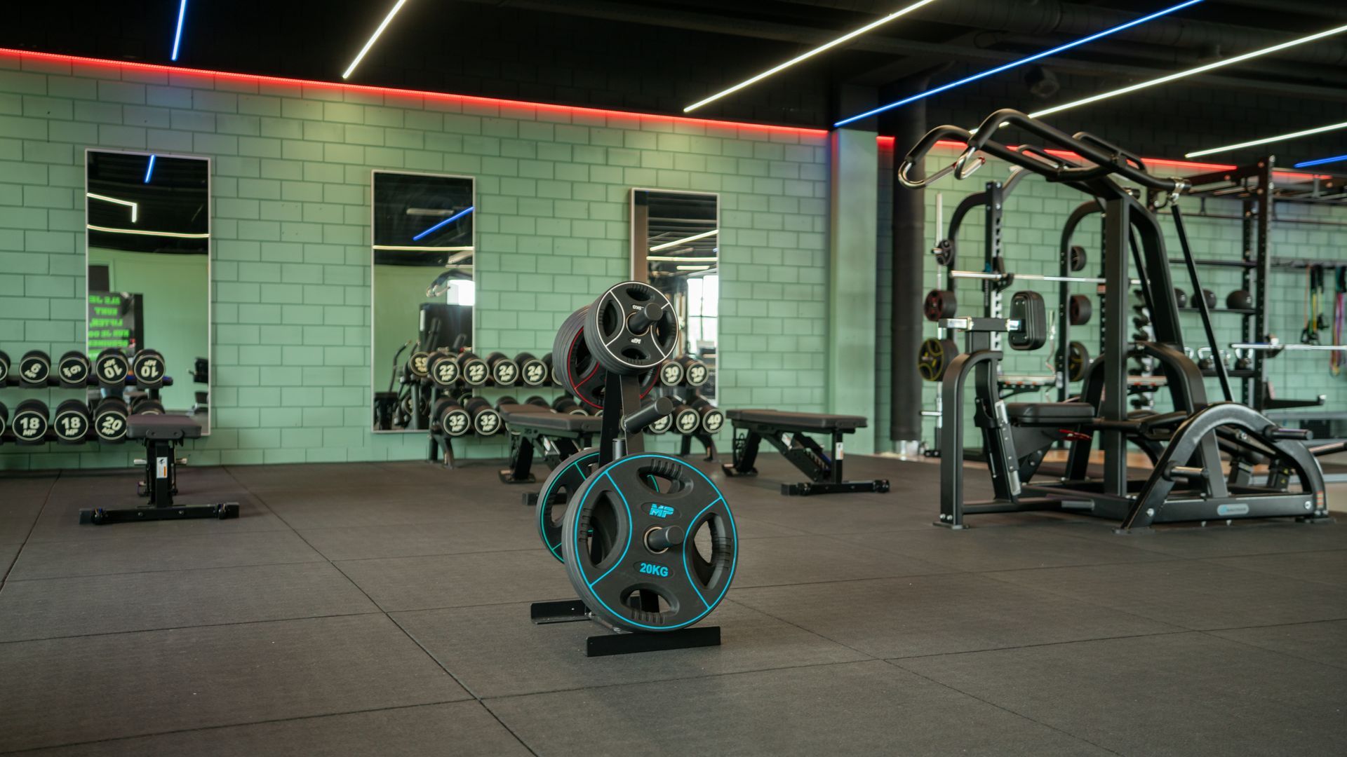 Een rij zwarte halters staat opgesteld in een sportschool