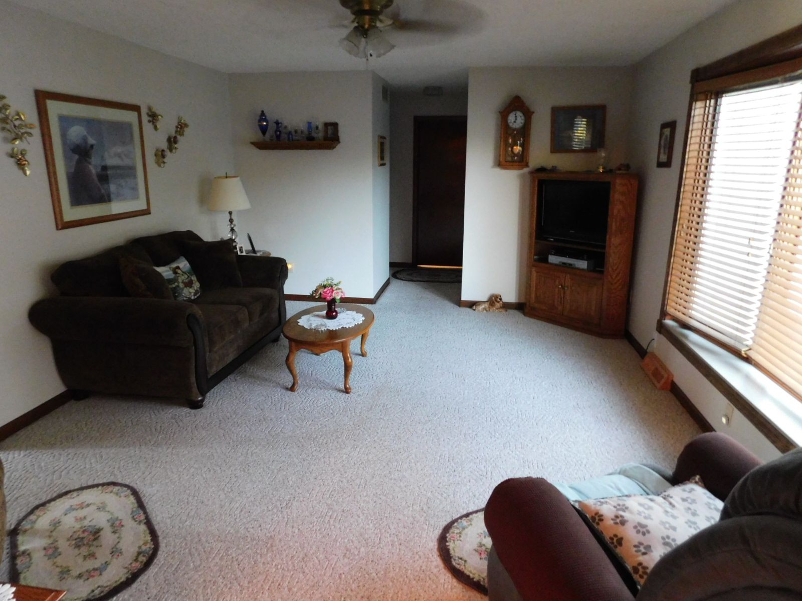 A living room with a couch a chair and a television