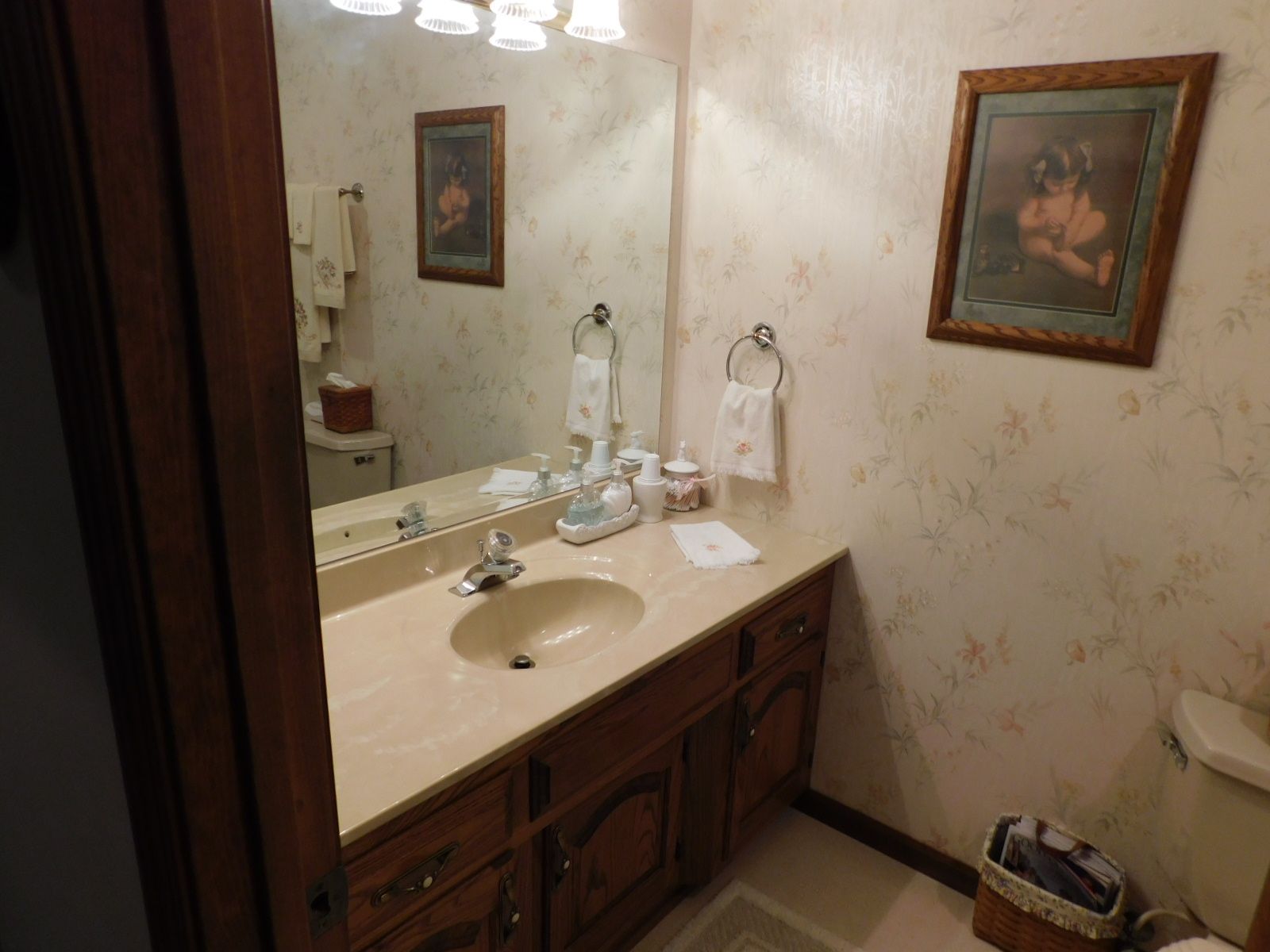 A bathroom with a sink , mirror and toilet.