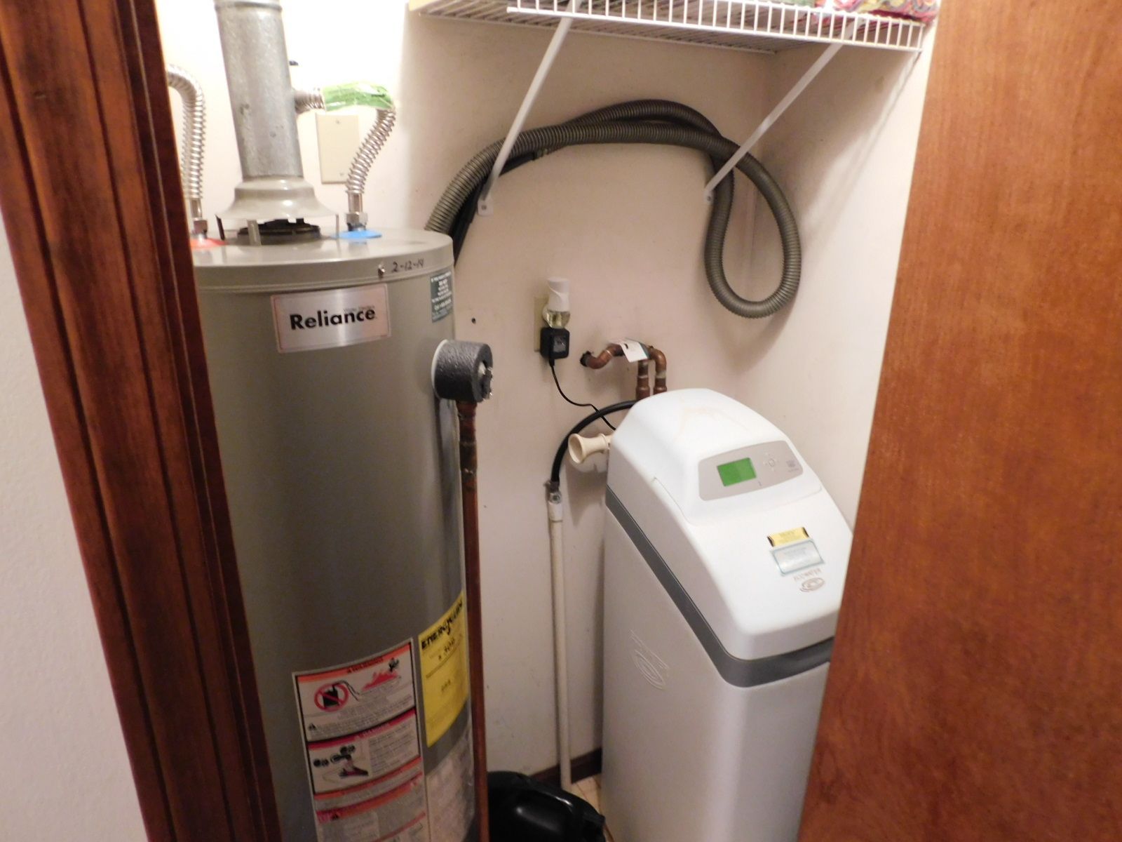 A room with a water heater and a water softener