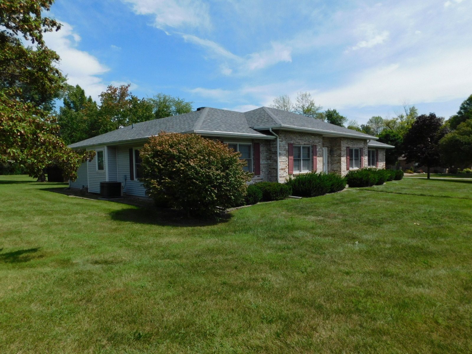 A house with a large lawn in front of it