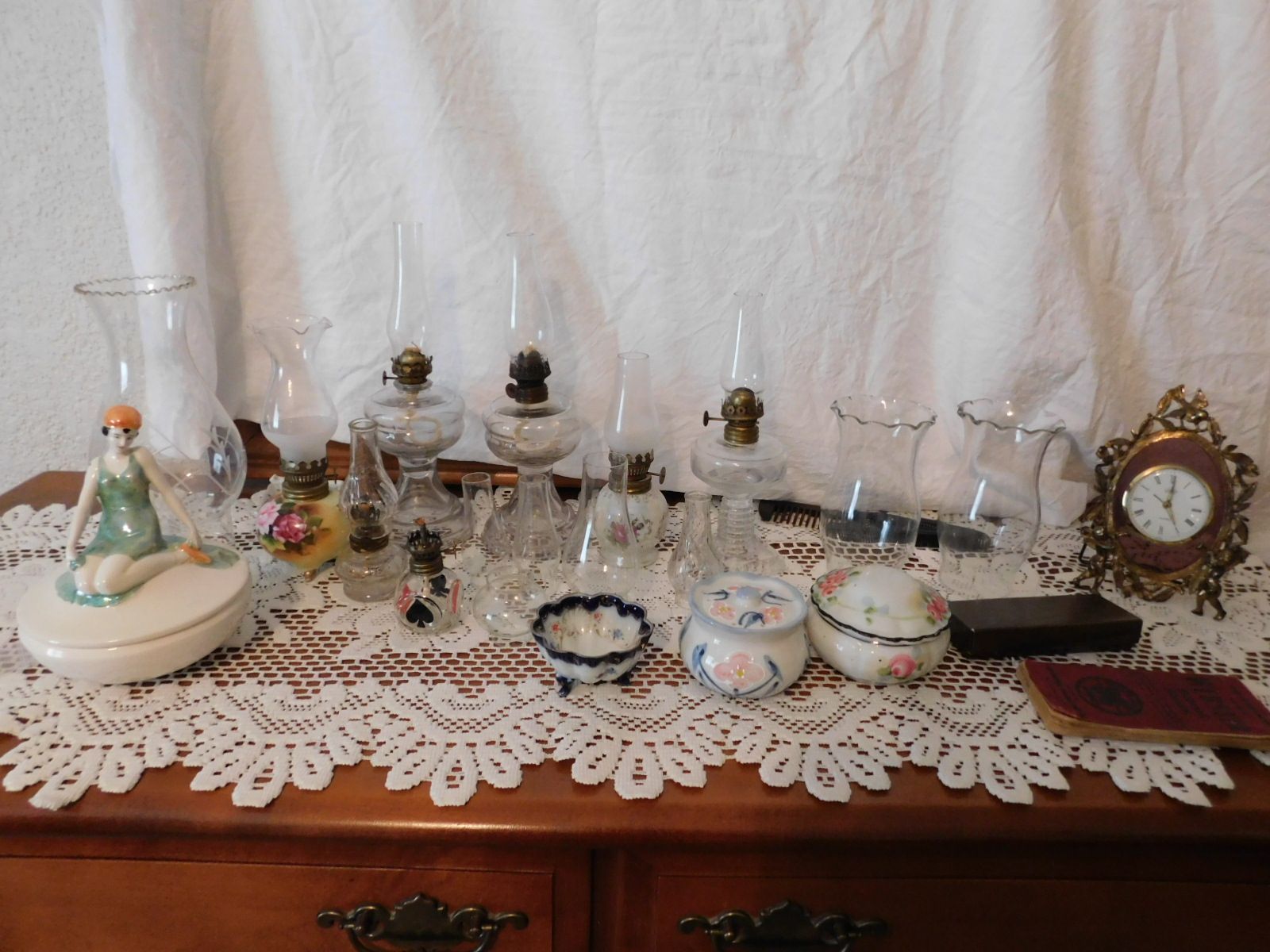 A table with a clock and vases on it
