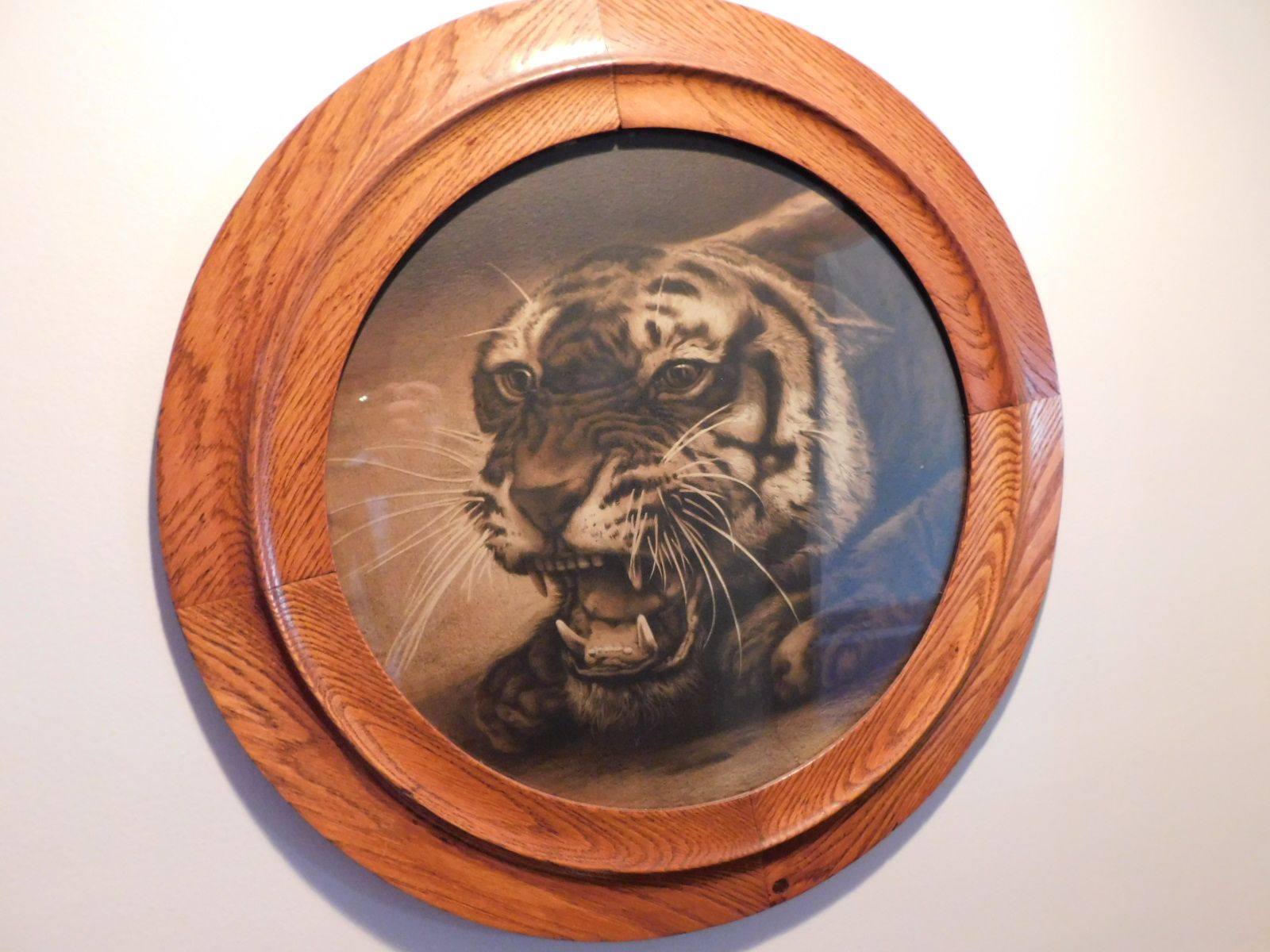 A picture of a tiger in a wooden frame