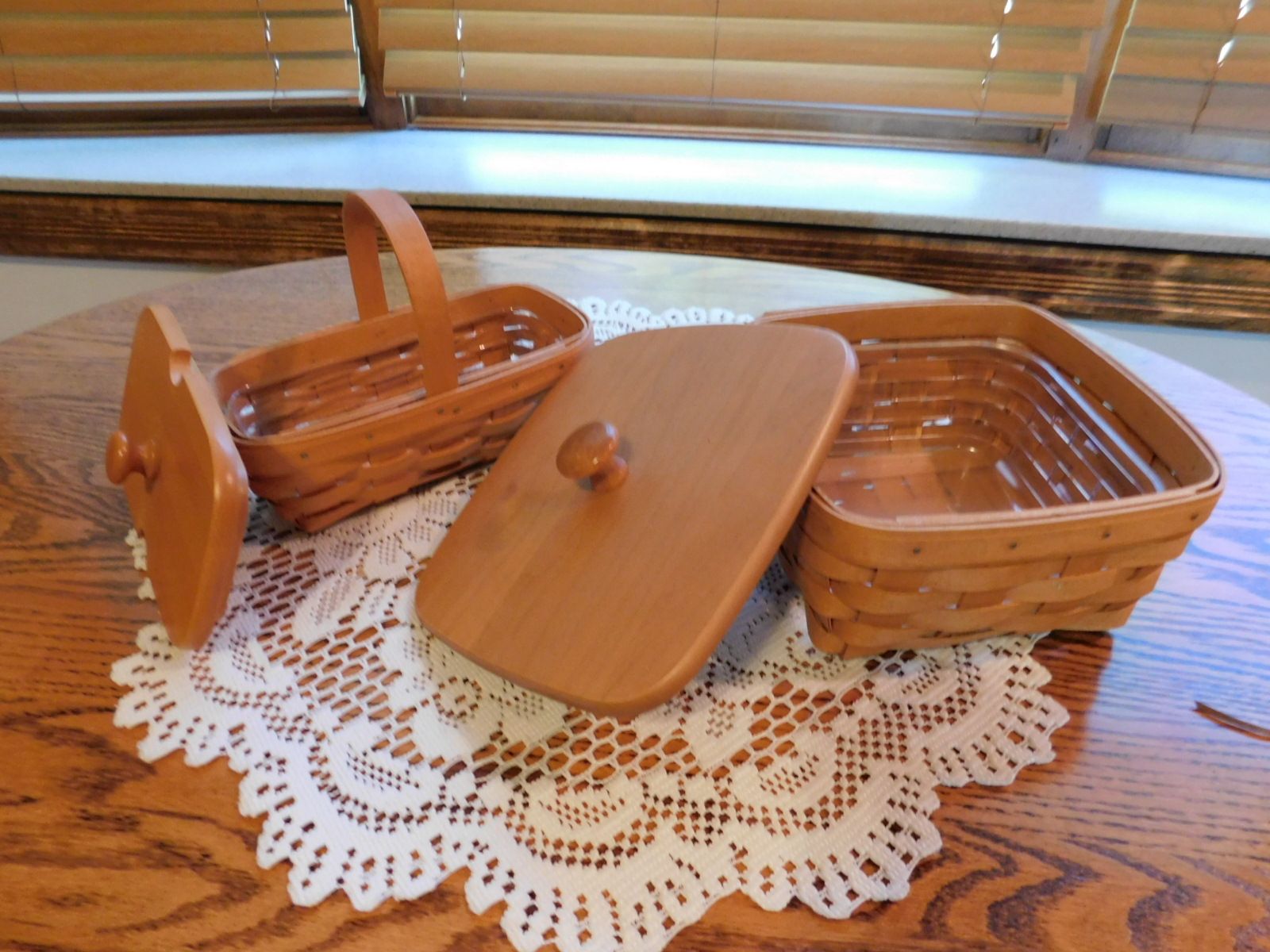 A wooden basket with a lid sits on a wooden table