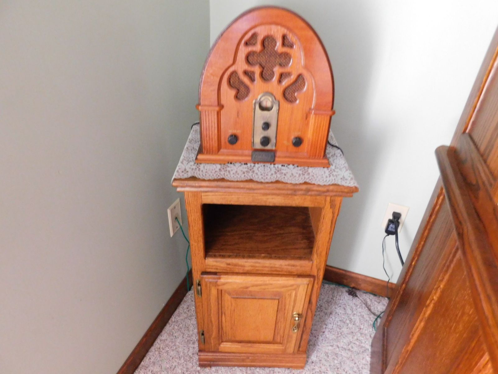 A small wooden cabinet with a radio on top of it