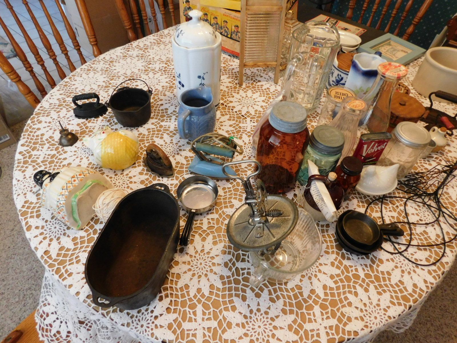 A table with a lot of items on it including a jar of coca cola