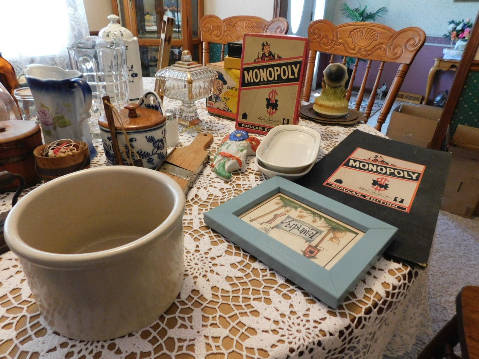 A table with many items on it including a monopoly board game