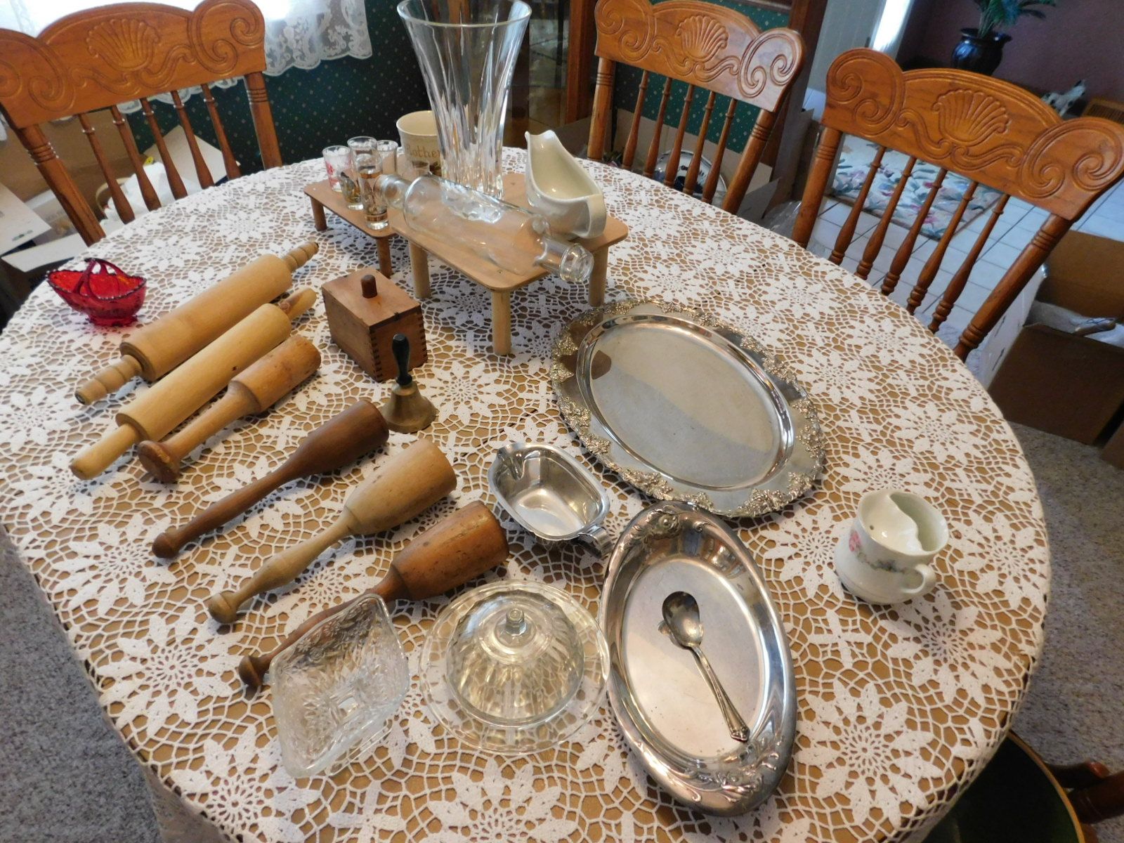 A table with a lace tablecloth and a spoon on it