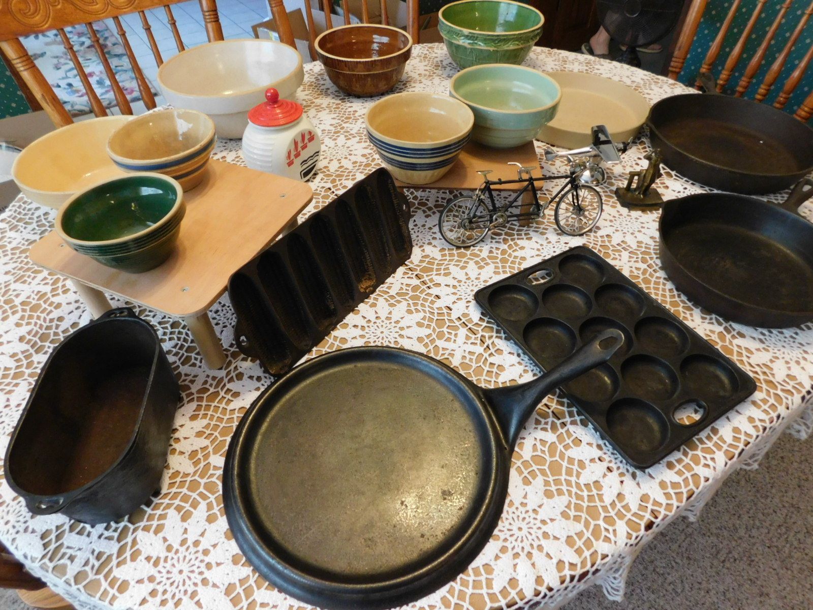 A table with a lot of bowls and pans on it