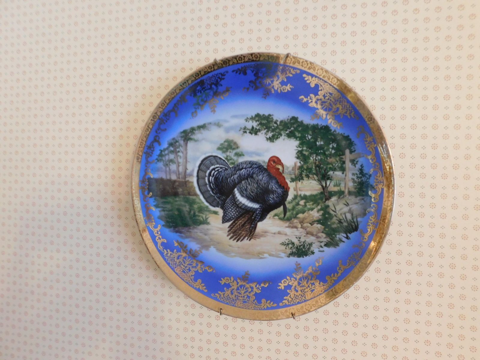 A blue and gold plate with a turkey on it