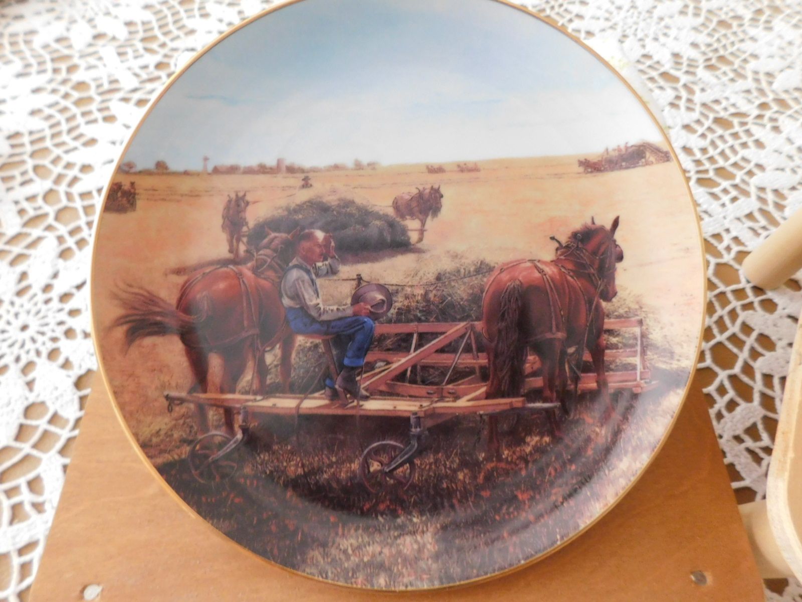 A plate with a picture of a man on a horse drawn carriage