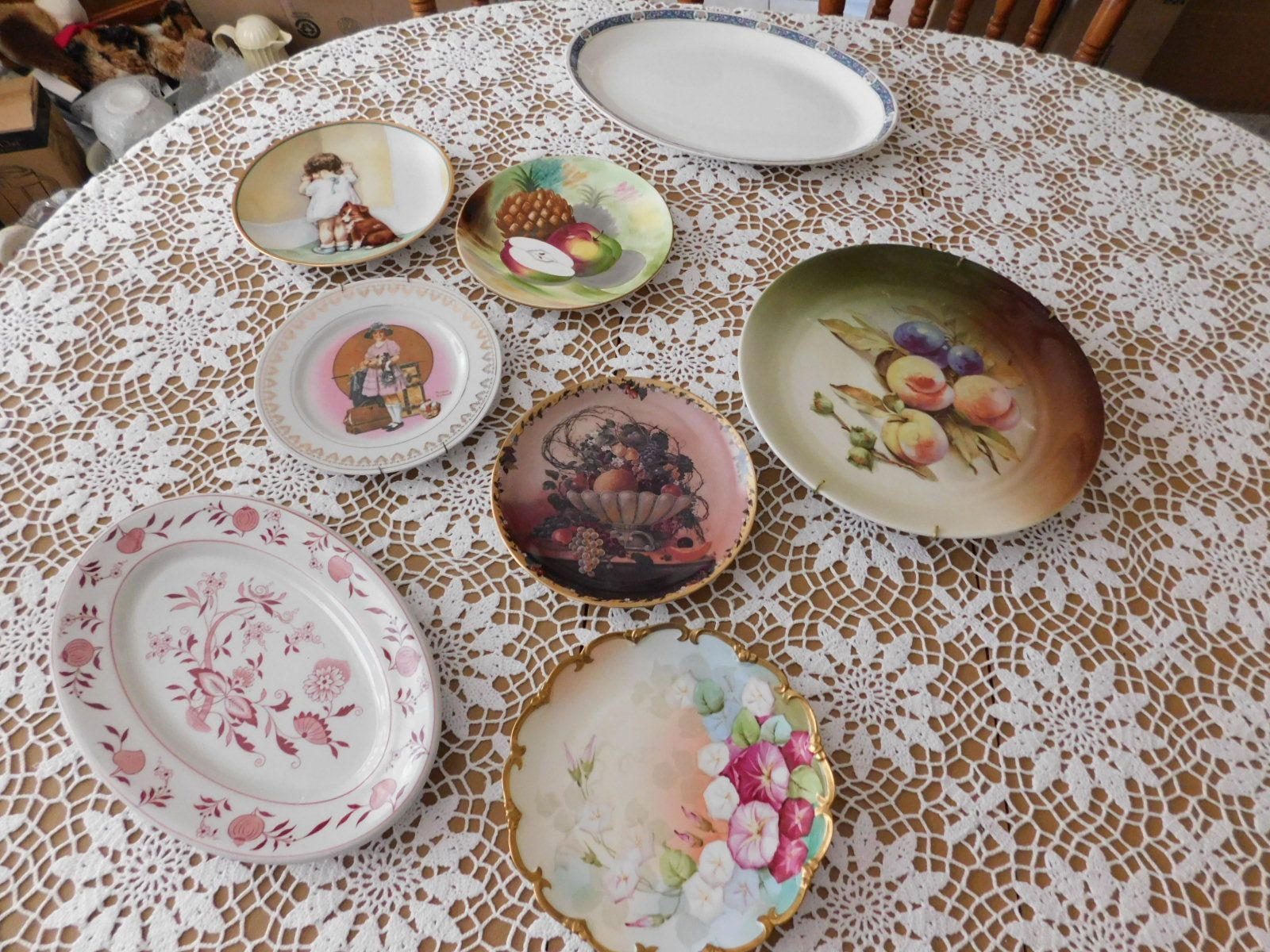 A table with a lace tablecloth and plates on it