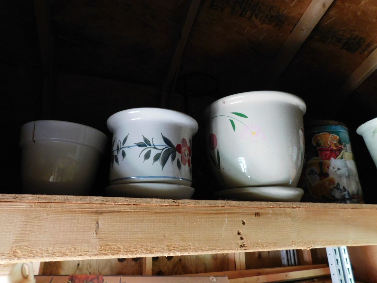 A wooden shelf with a bunch of pots on it
