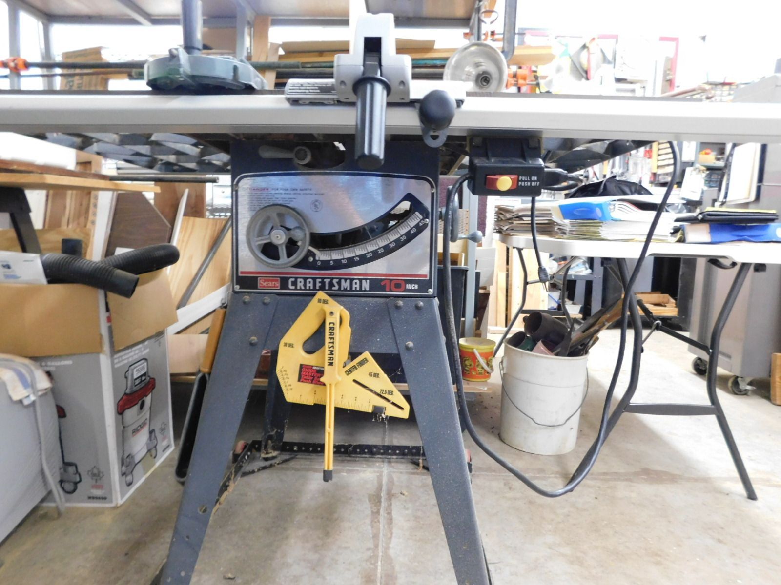A craftsman table saw is sitting in a garage