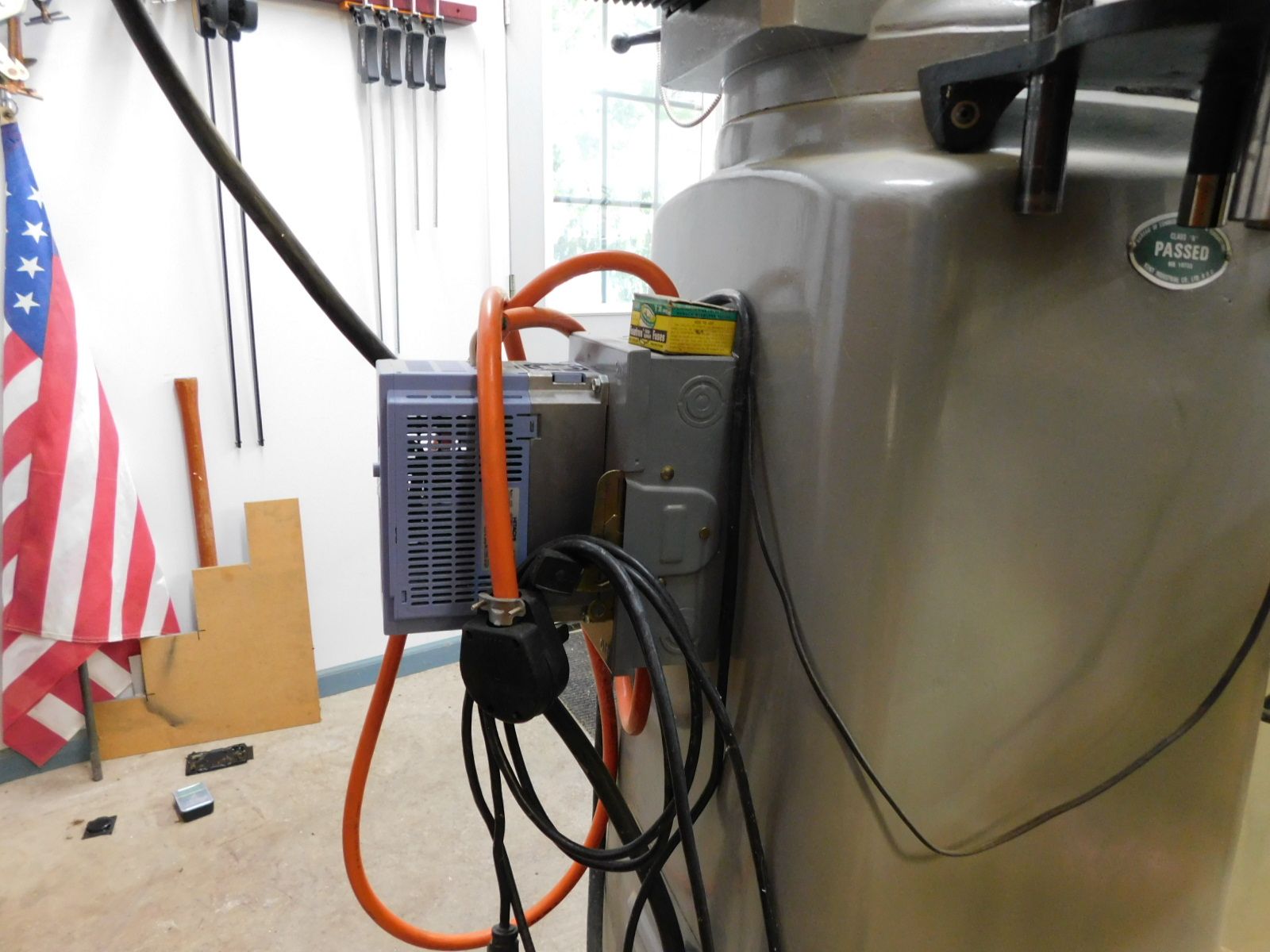 An american flag is hanging on the wall behind a machine