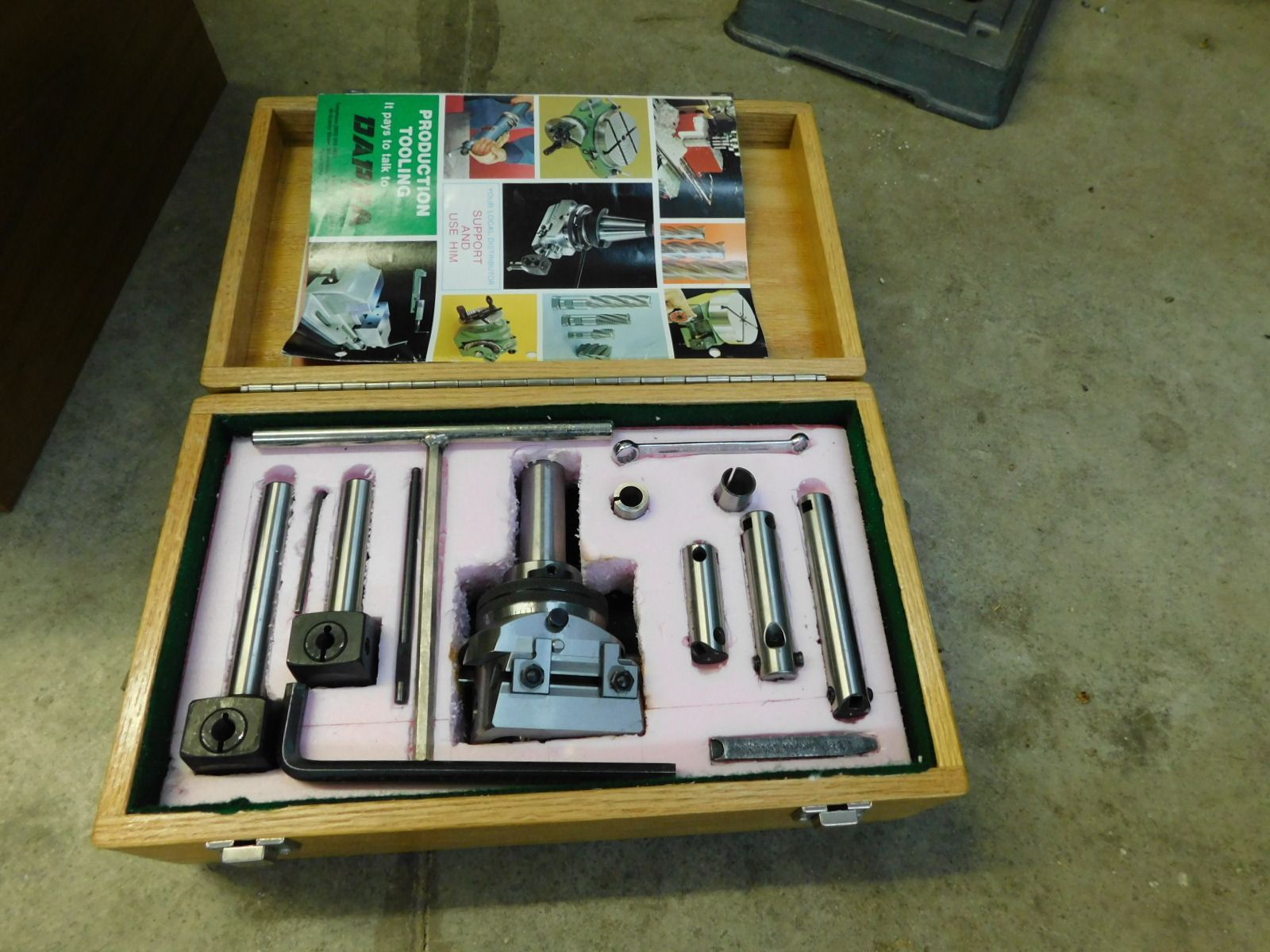 A wooden box with a bunch of tools inside of it