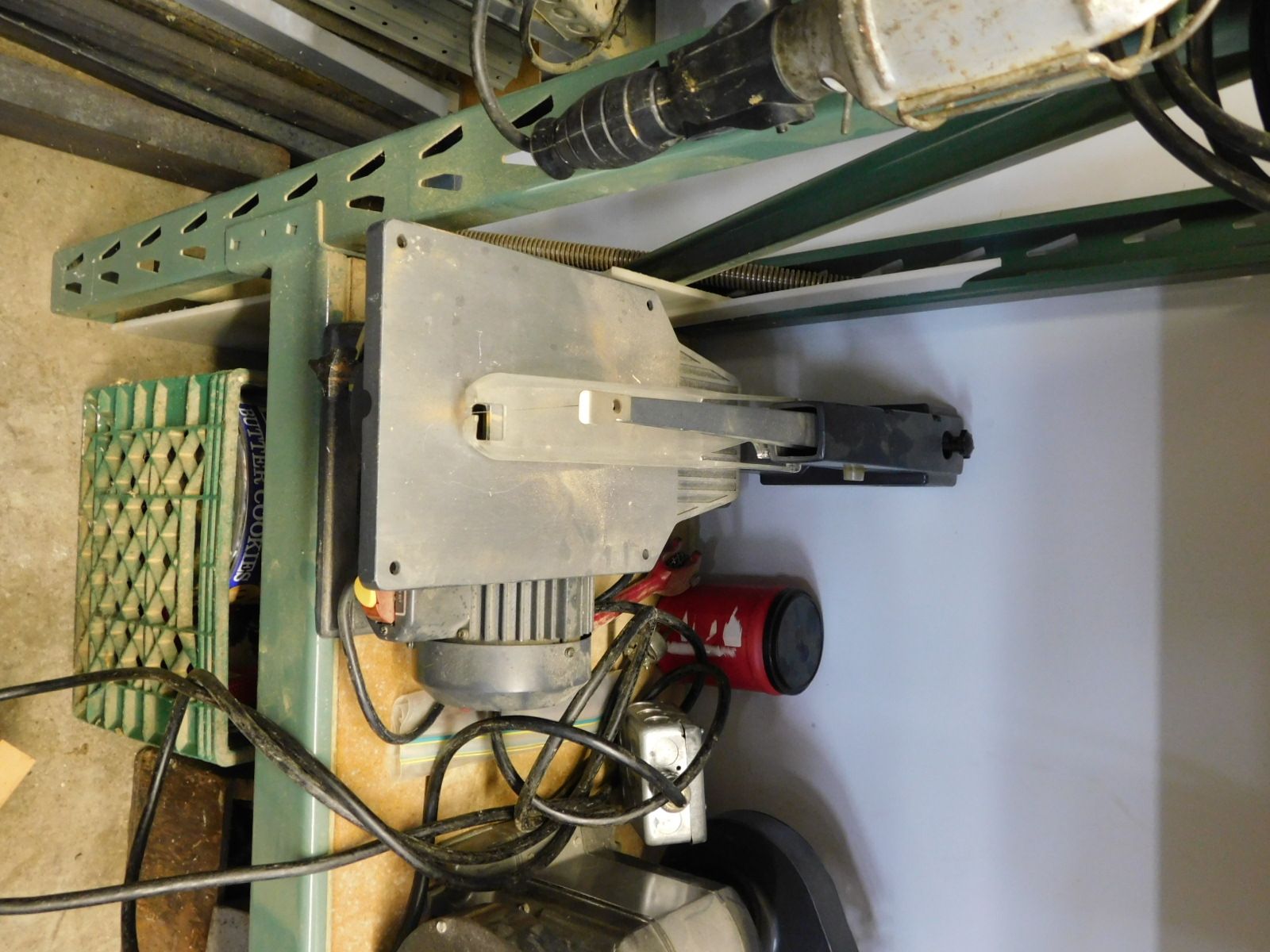 A circular saw is sitting on top of a wooden table.