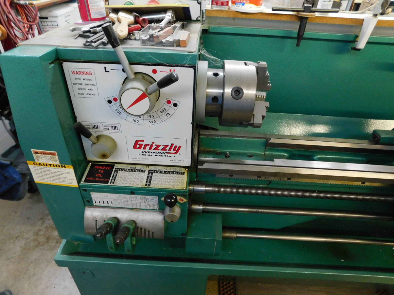 A grizzly lathe is sitting on the floor in a workshop