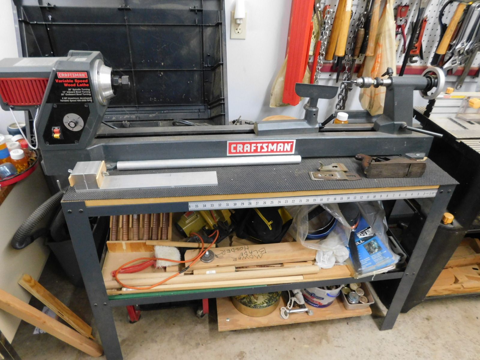 A craftsman lathe is sitting on top of a workbench